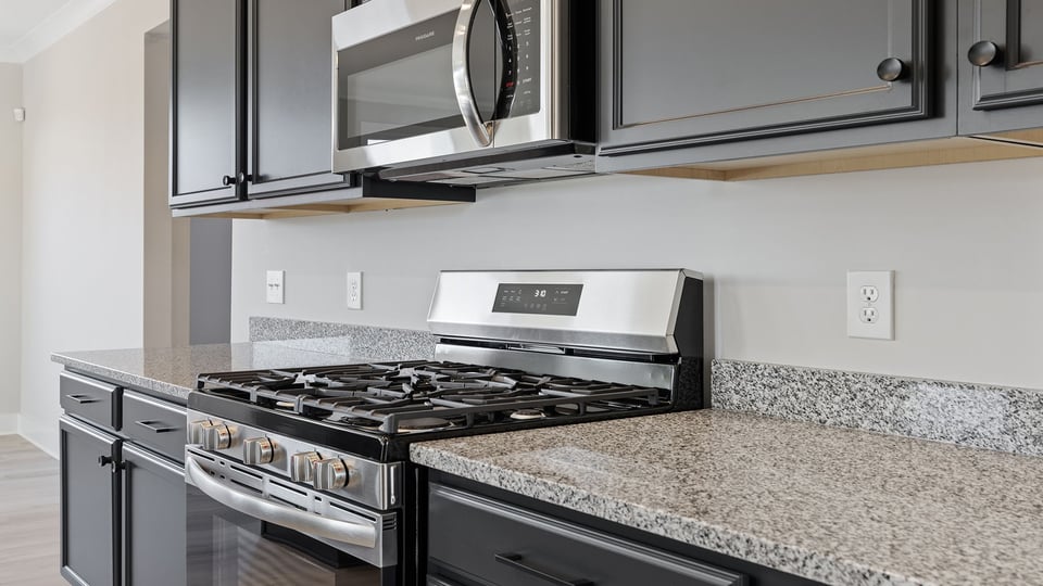 Kitchen with cabinets and window.