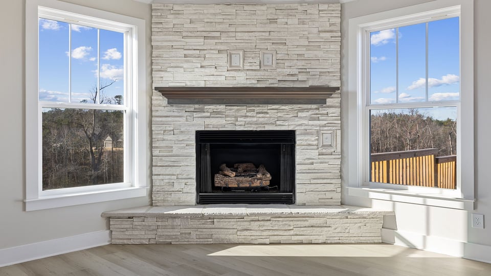 Fireplace with windows in living area.