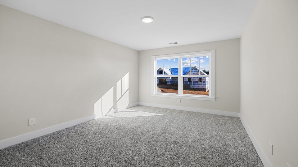 Bedroom with carpet and window.