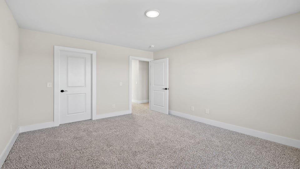 Bedroom with carpet and window.