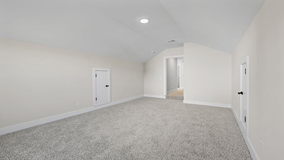Bonus room with carpet and window.