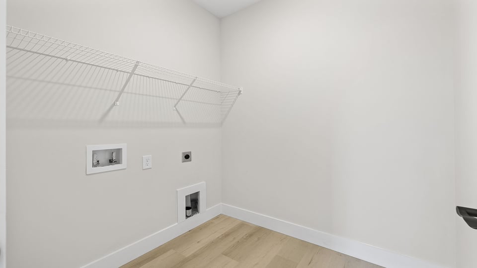 Laundry room with shelf.