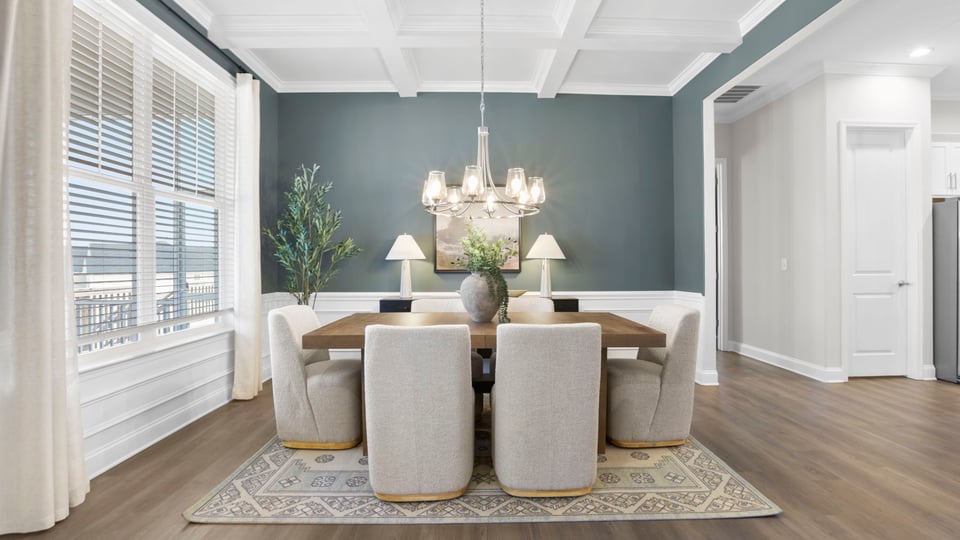 Formal dining room with windows.