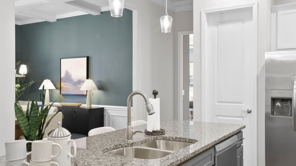 Kitchen with quartz countertops and island.