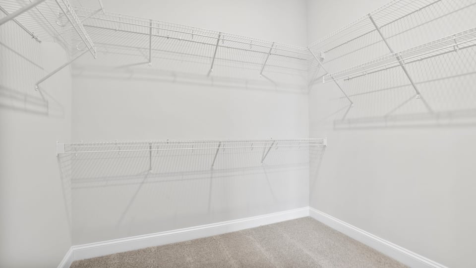 Walk in closet of primary bedroom.