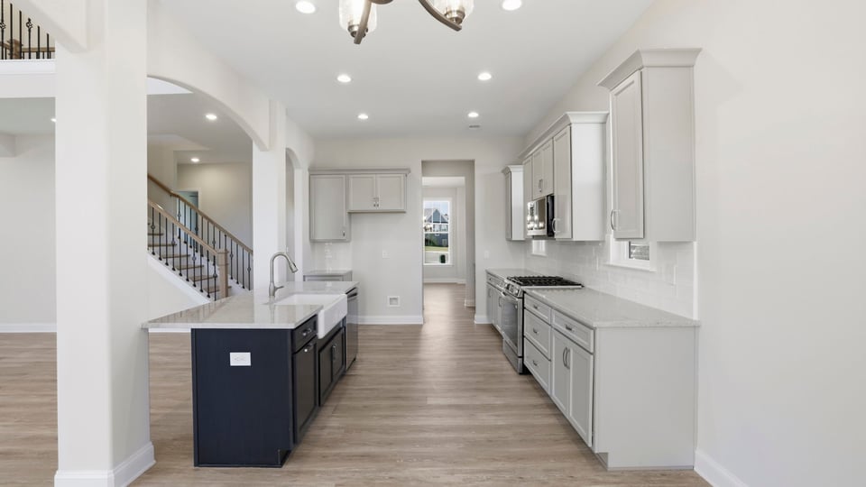 Kitchen with quartz countertops and stainless steel appliances.