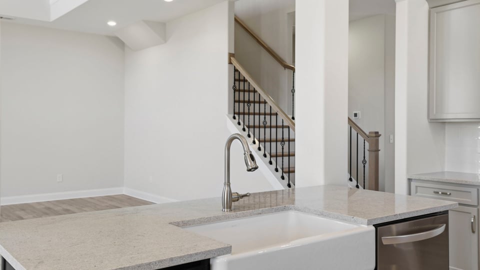Kitchen with quartz countertops and stainless steel appliances.