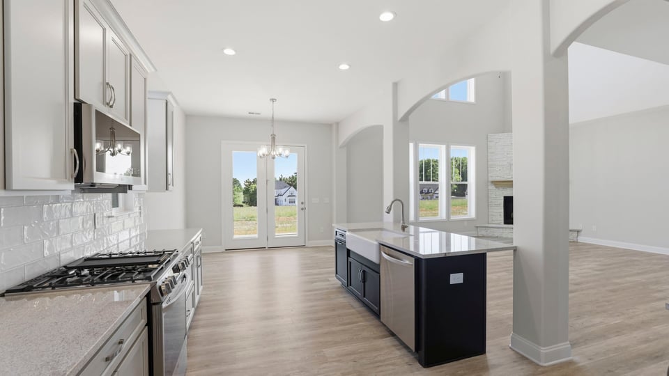 Kitchen with quartz countertops and stainless steel appliances.