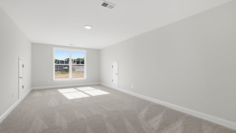 Bedroom with carpet and window.