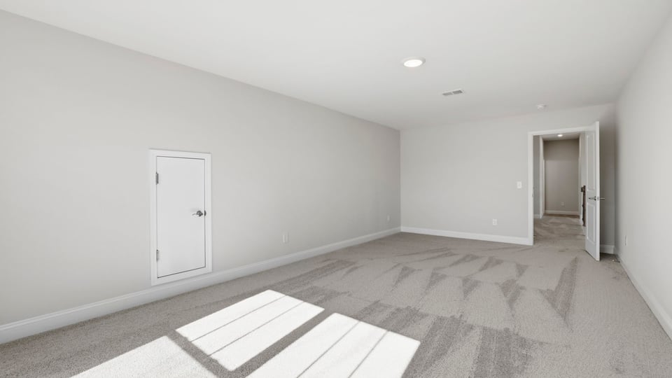 Bedroom with carpet and window.