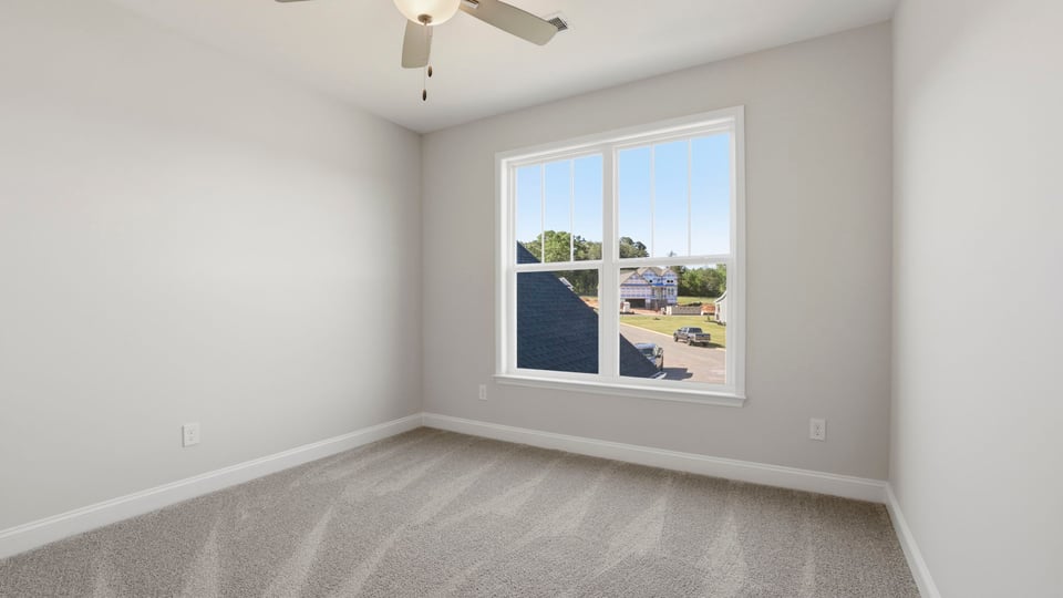 Bedroom with carpet and window.