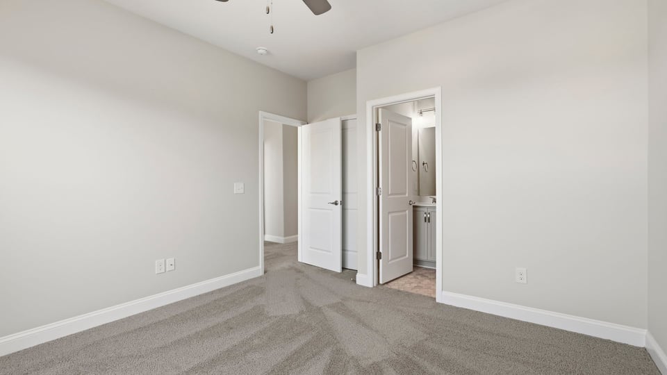 Bedroom with carpet and window.
