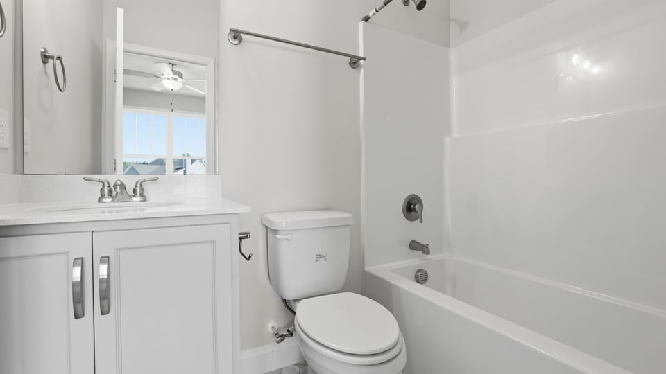 Bathroom with single vanity sink and bathtub.