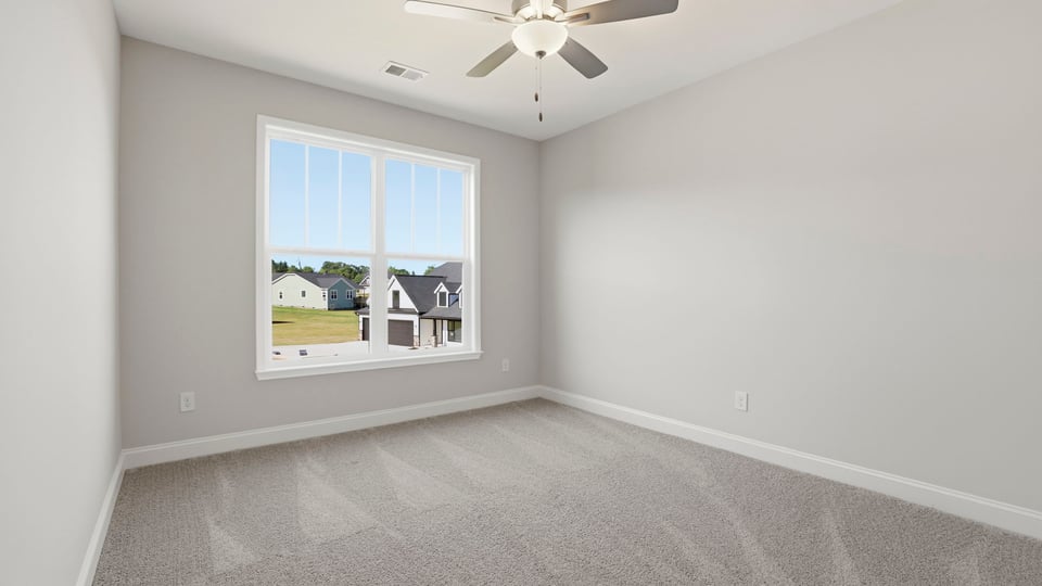 Bedroom with carpet and window.