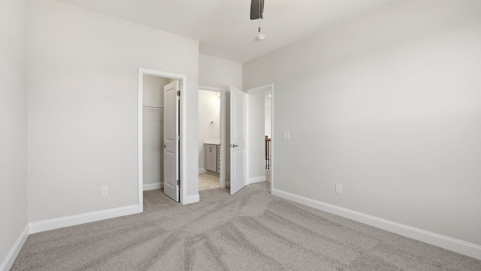Bedroom with carpet and window.