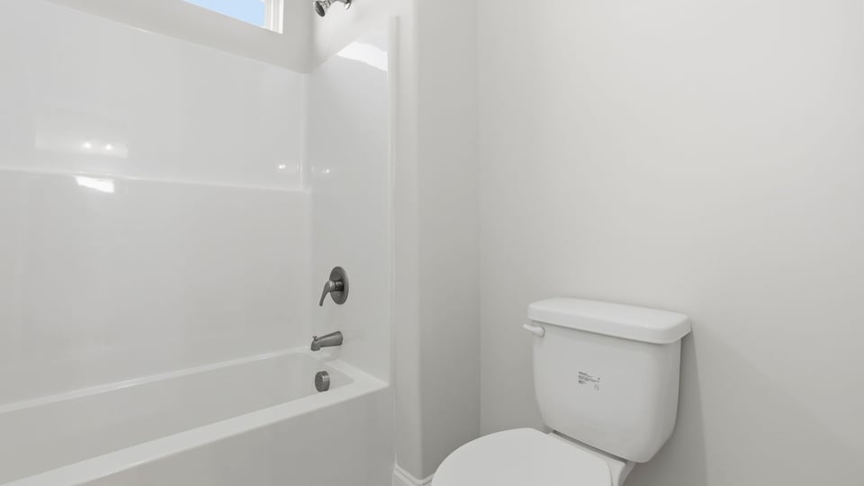 Bathroom with toilet and bathtub.