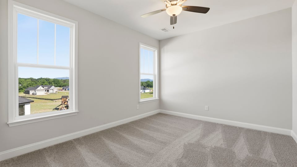 Bedroom with carpet and window.