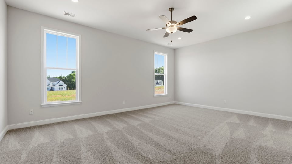 Bedroom with carpet and window.