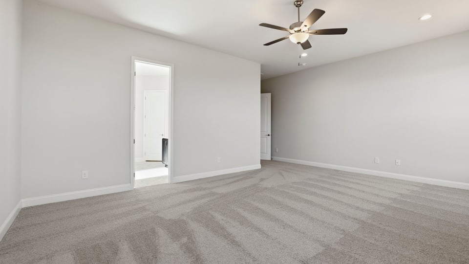 Bedroom with carpet and window.