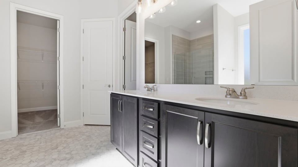 Bathroom with double vanity sink and closet.