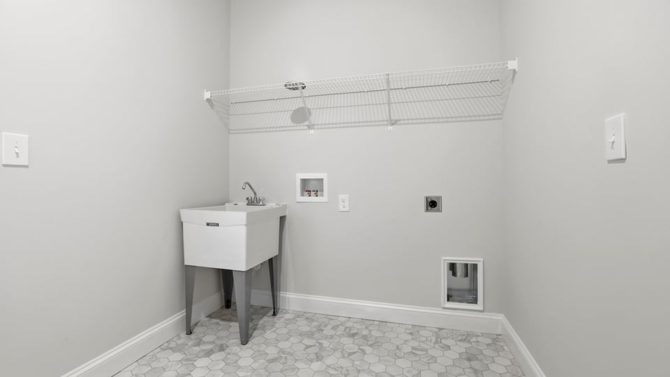 Laundry room with hanging storage racks.