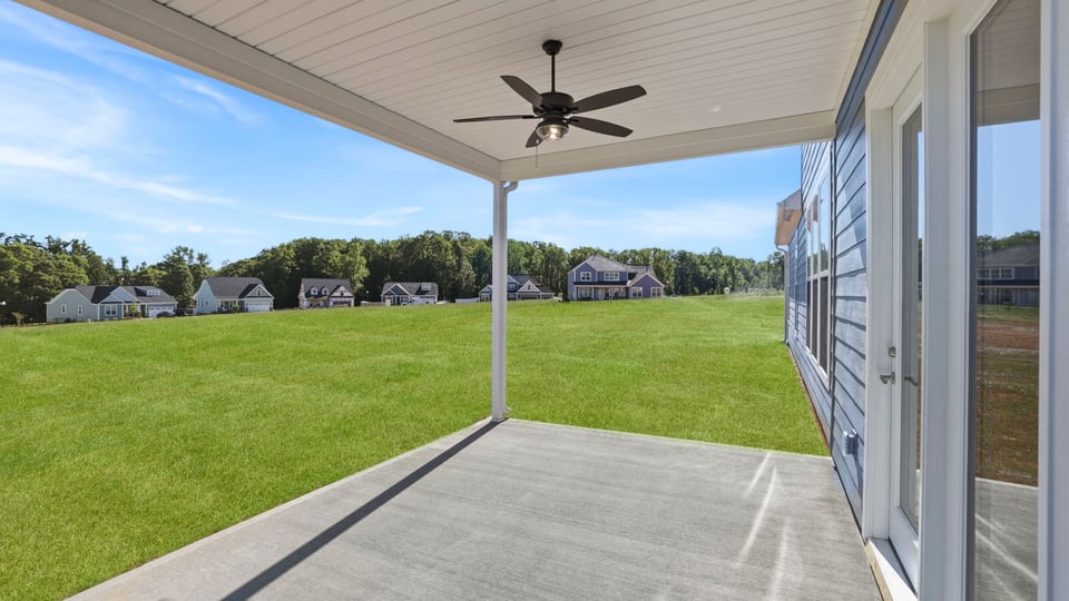 Back exterior of home with covered patio.