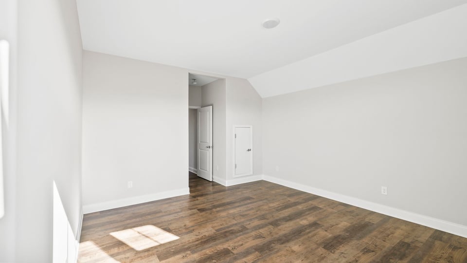 Bedroom of home with windows.