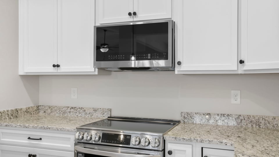 Kitchen and island with granite counter tops.