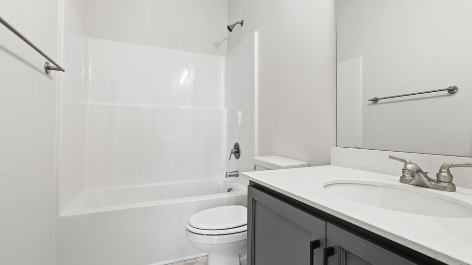 Bathroom with single vanity sink and tub.