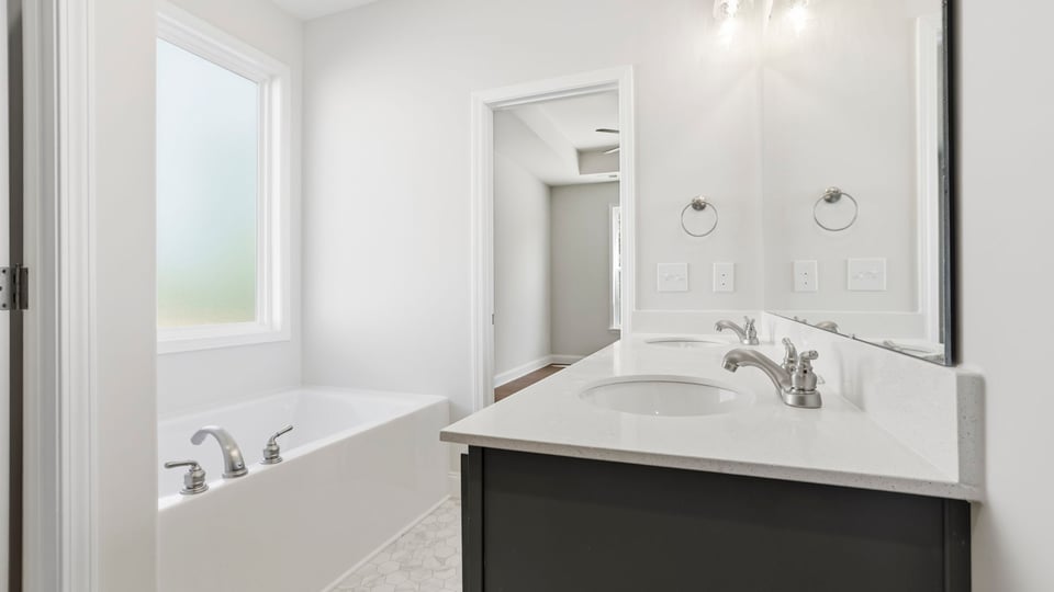 Bathroom with single vanity sink and tub.