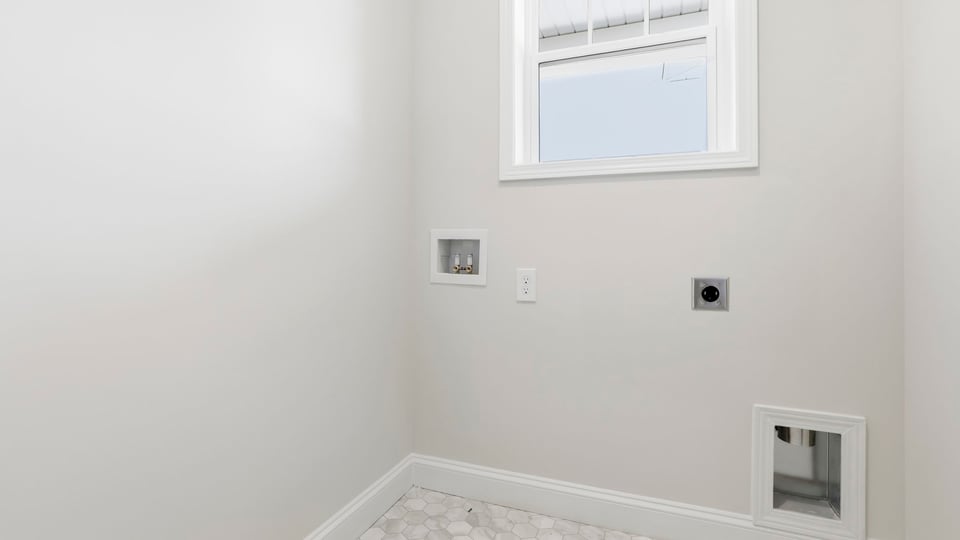 Laundry room with hanging storage racks.
