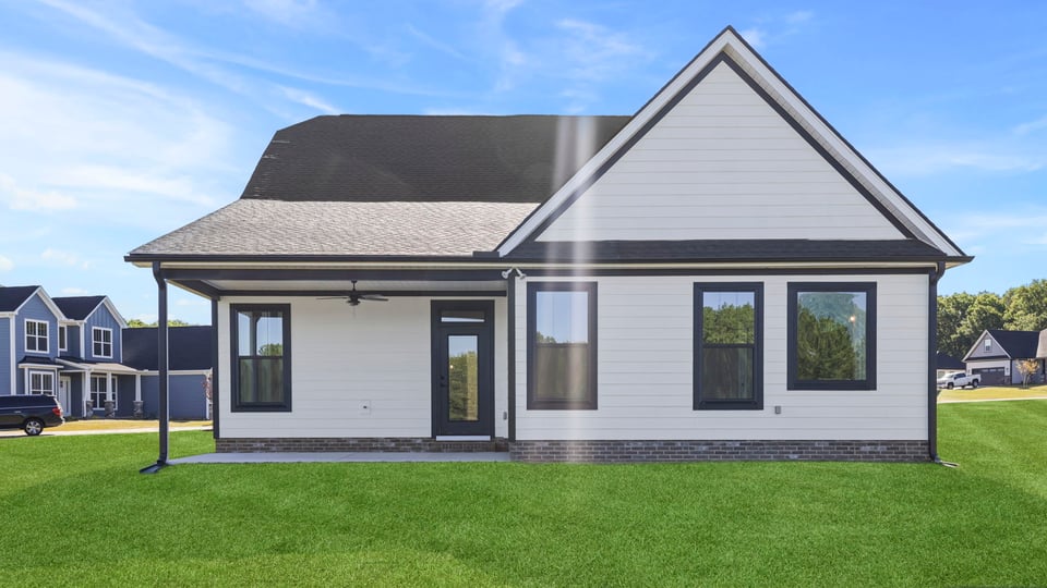 Back exterior of home with large backyard.