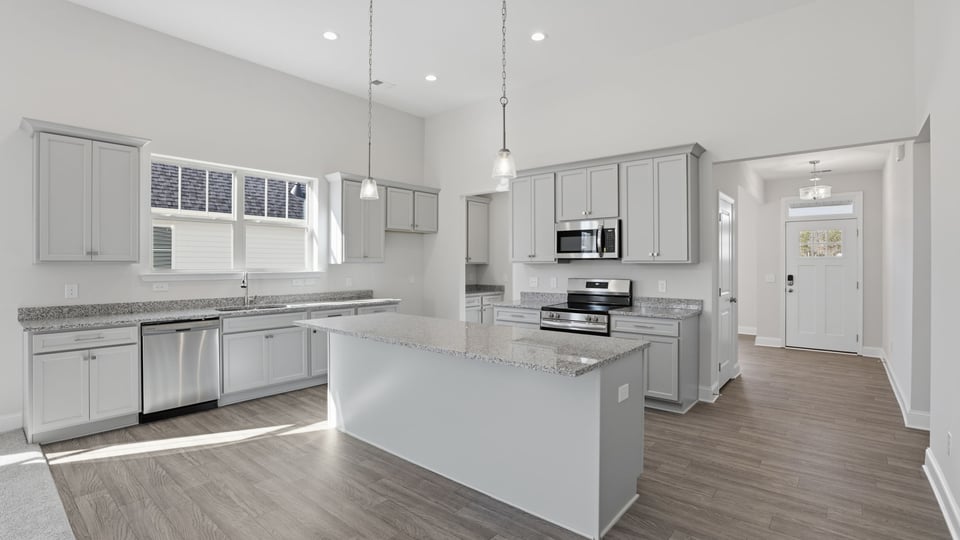 Kitchen and island with granite countertops.
