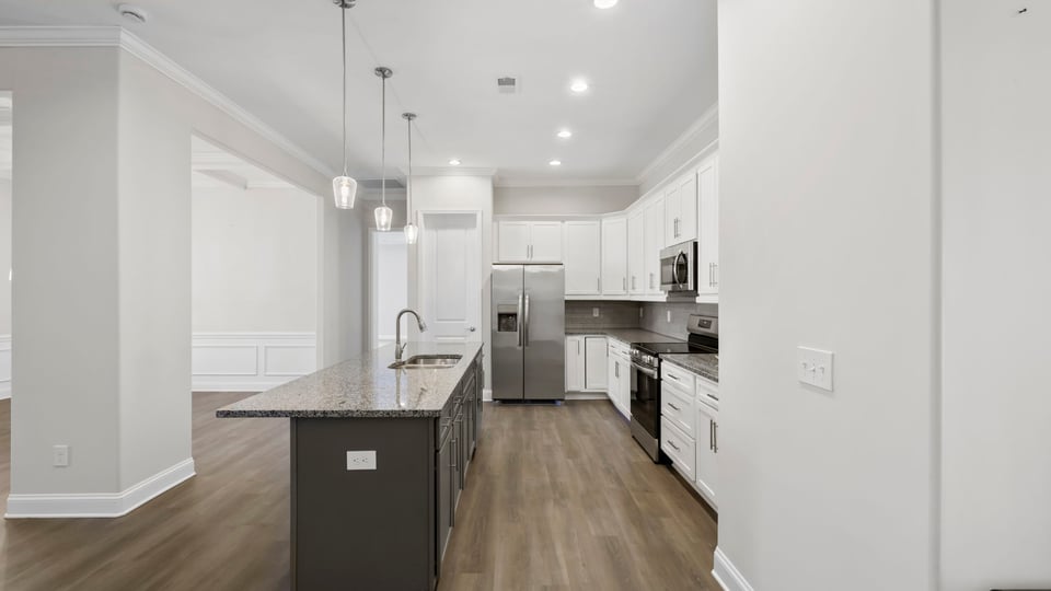 Kitchen and island with granite counter tops.
