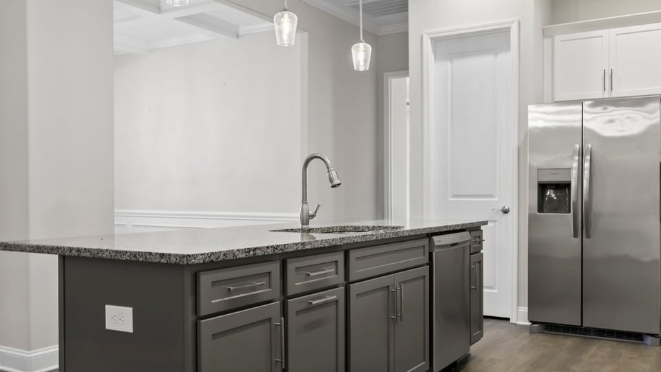 Kitchen and island with granite counter tops.