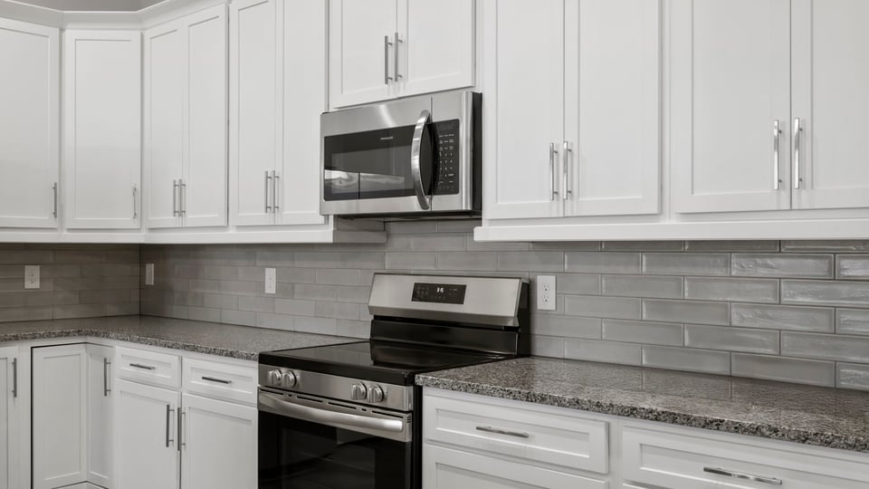 Kitchen and island with granite counter tops.