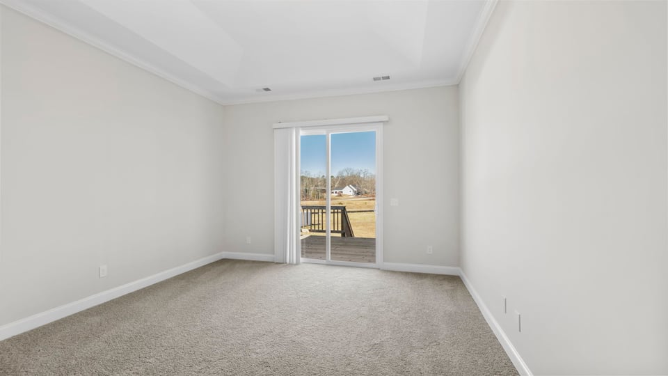 Bedroom with carpet and windows.