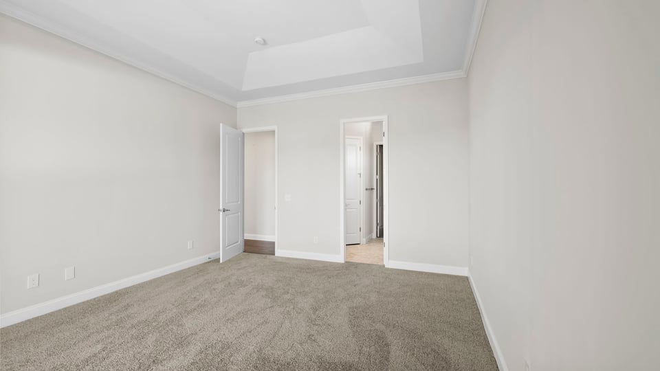 Bedroom with carpet and windows.