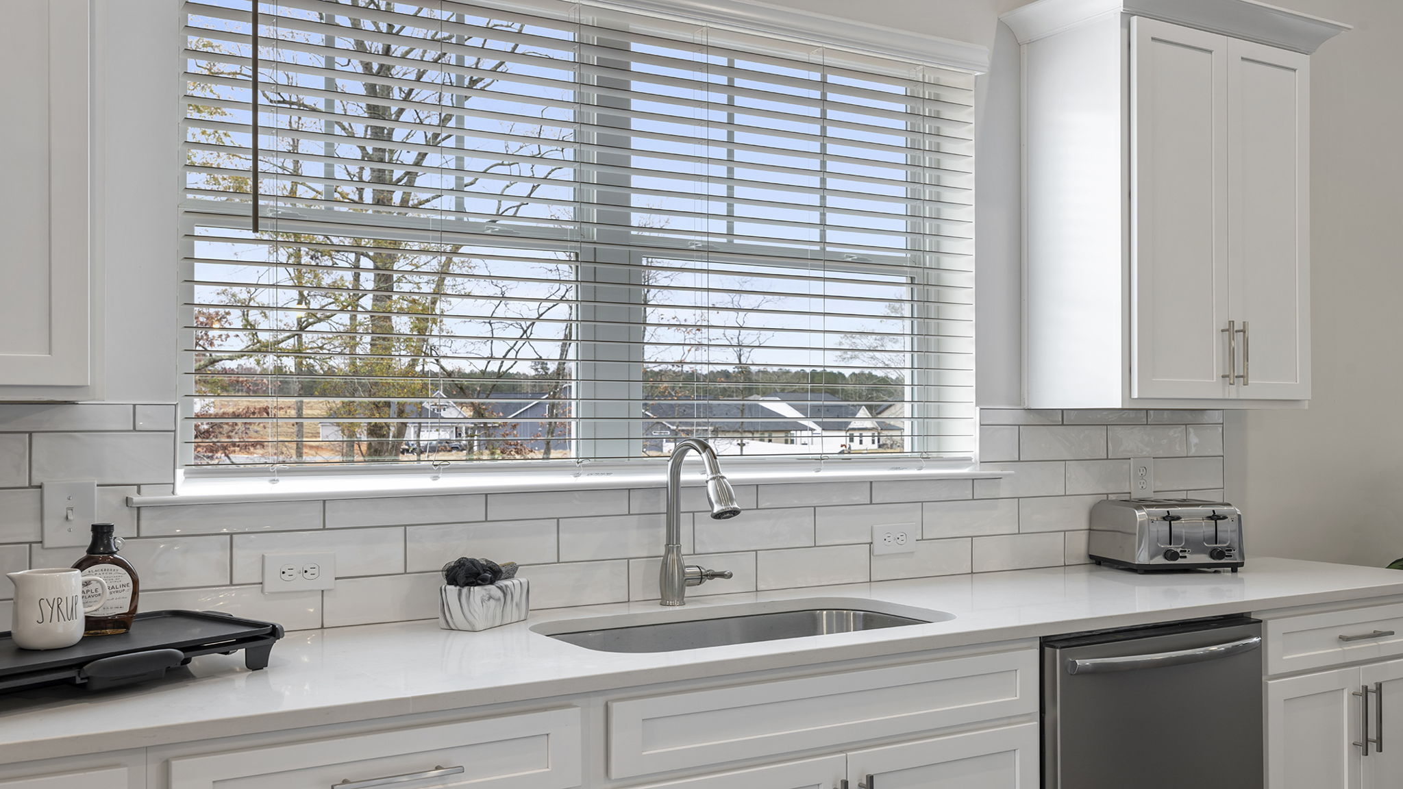 Kitchen with island and quartz countertops.