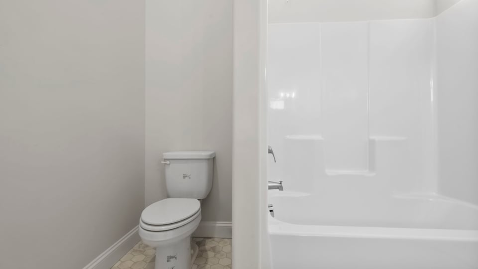 Bathroom with toilet and tub.