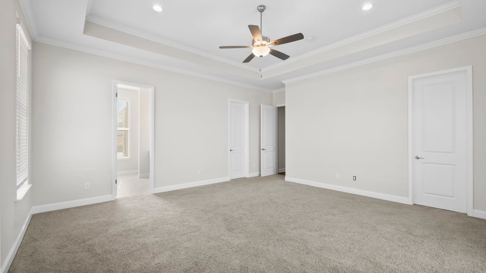 Bedroom with carpet and windows.