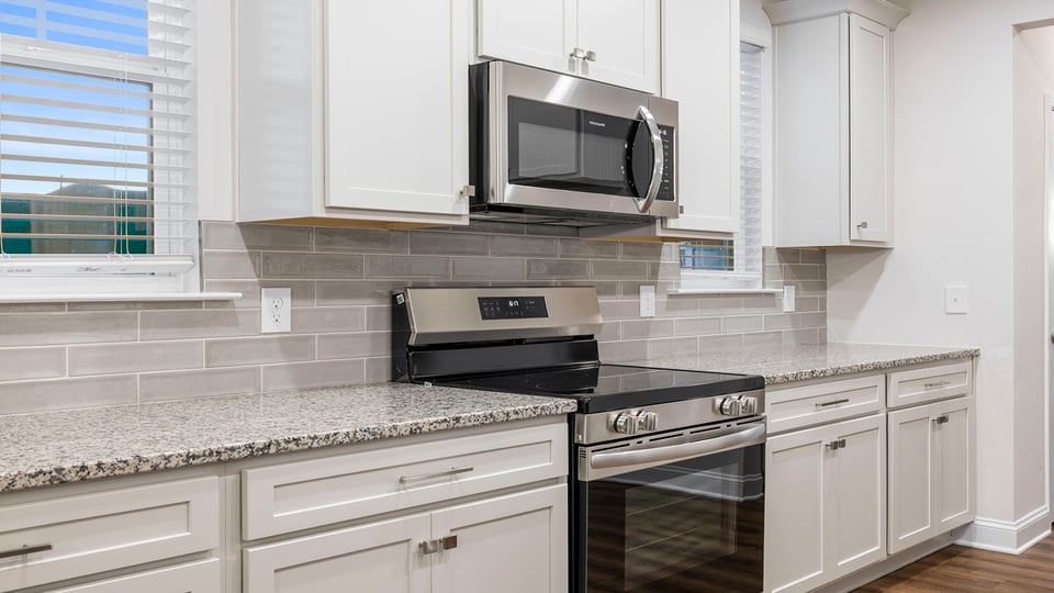Kitchen with granite countertops and stainless steel appliances.