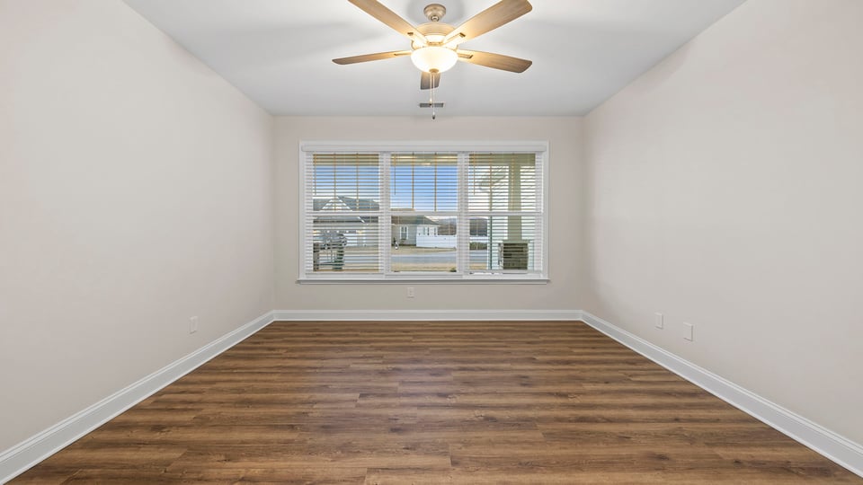 Dining room with chandelier and windows.