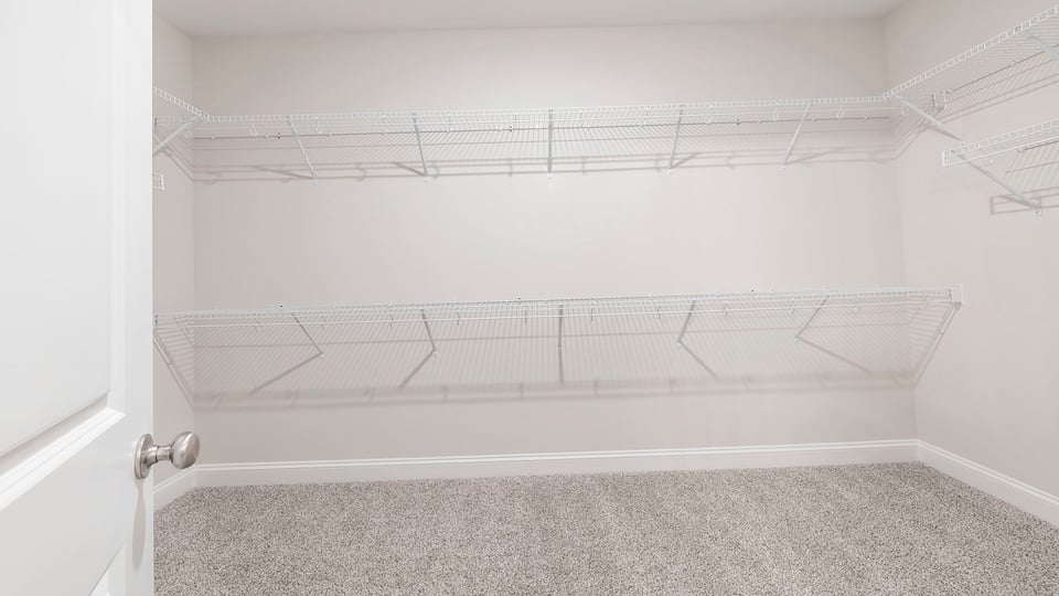 Walk in closet with shelves.