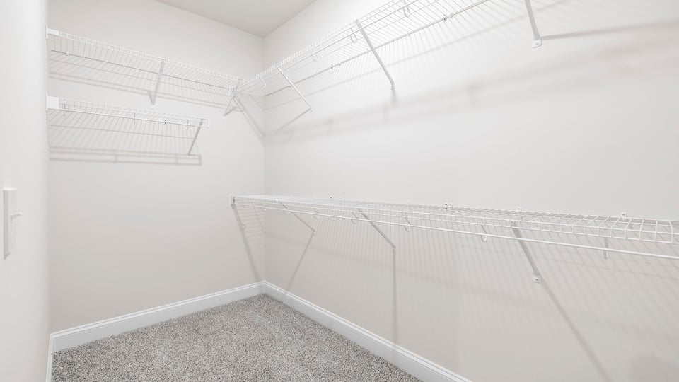 Walk in closet with shelves.