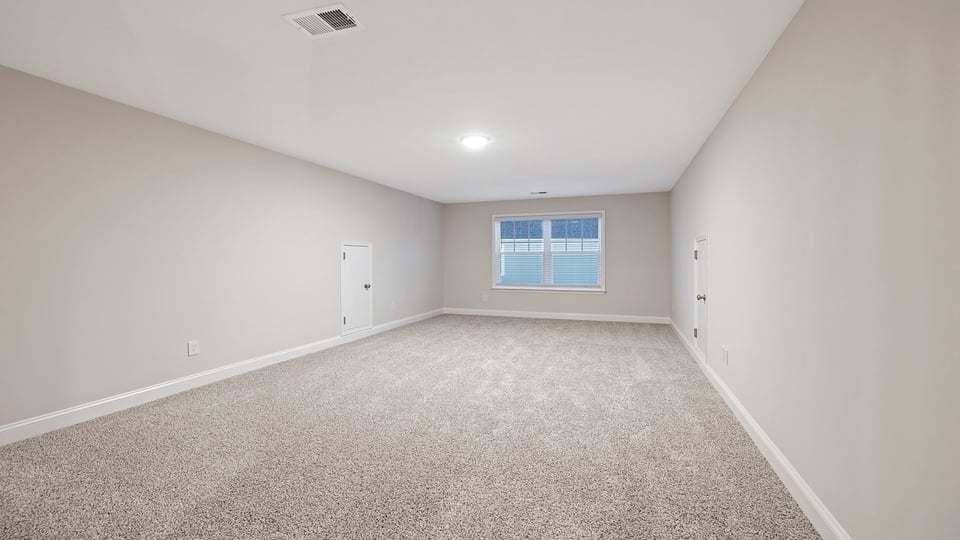Bedroom with carpet and windows.
