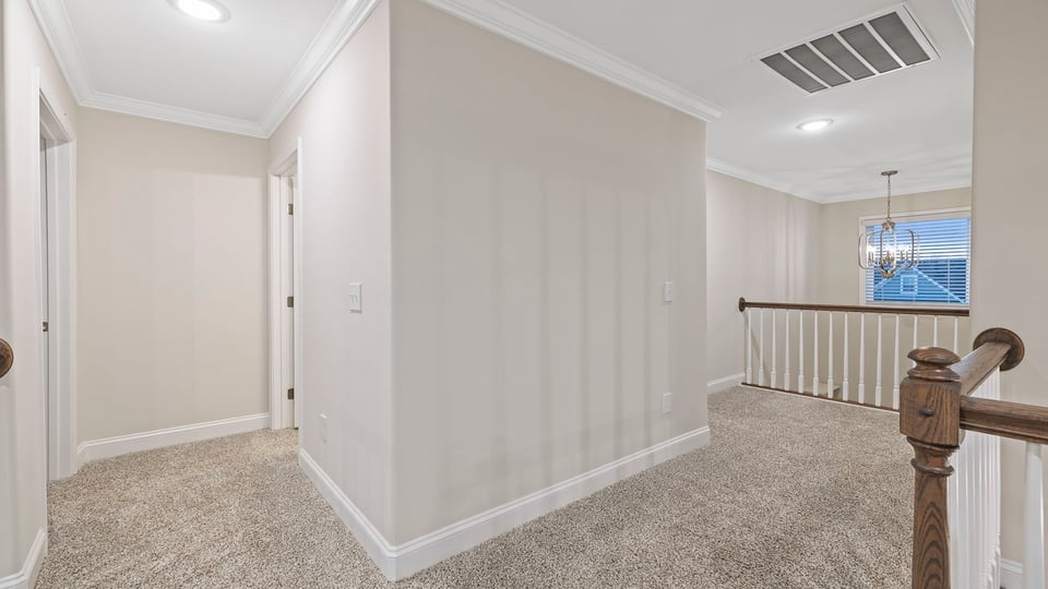 Bedroom with carpet and windows.
