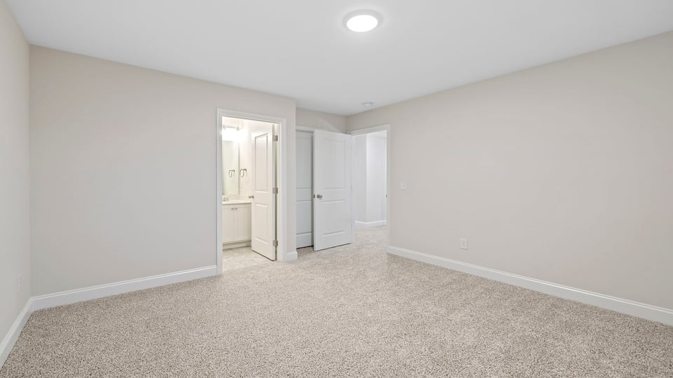 Bedroom with carpet and windows.