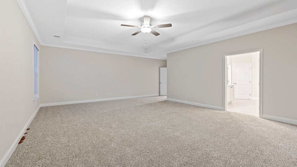 Bedroom with carpet and windows.