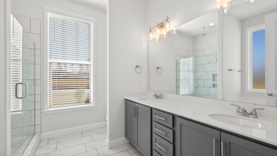 Bathroom with double sink vanity and window.